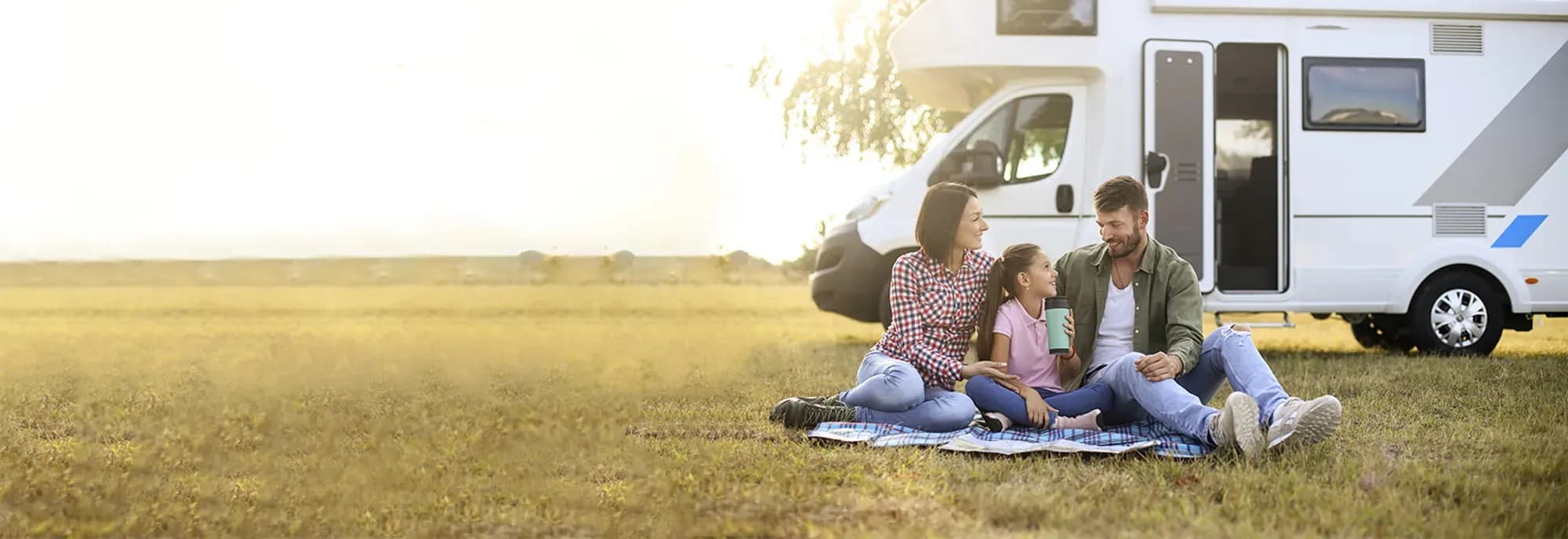 Family relaxing beside their motorhome